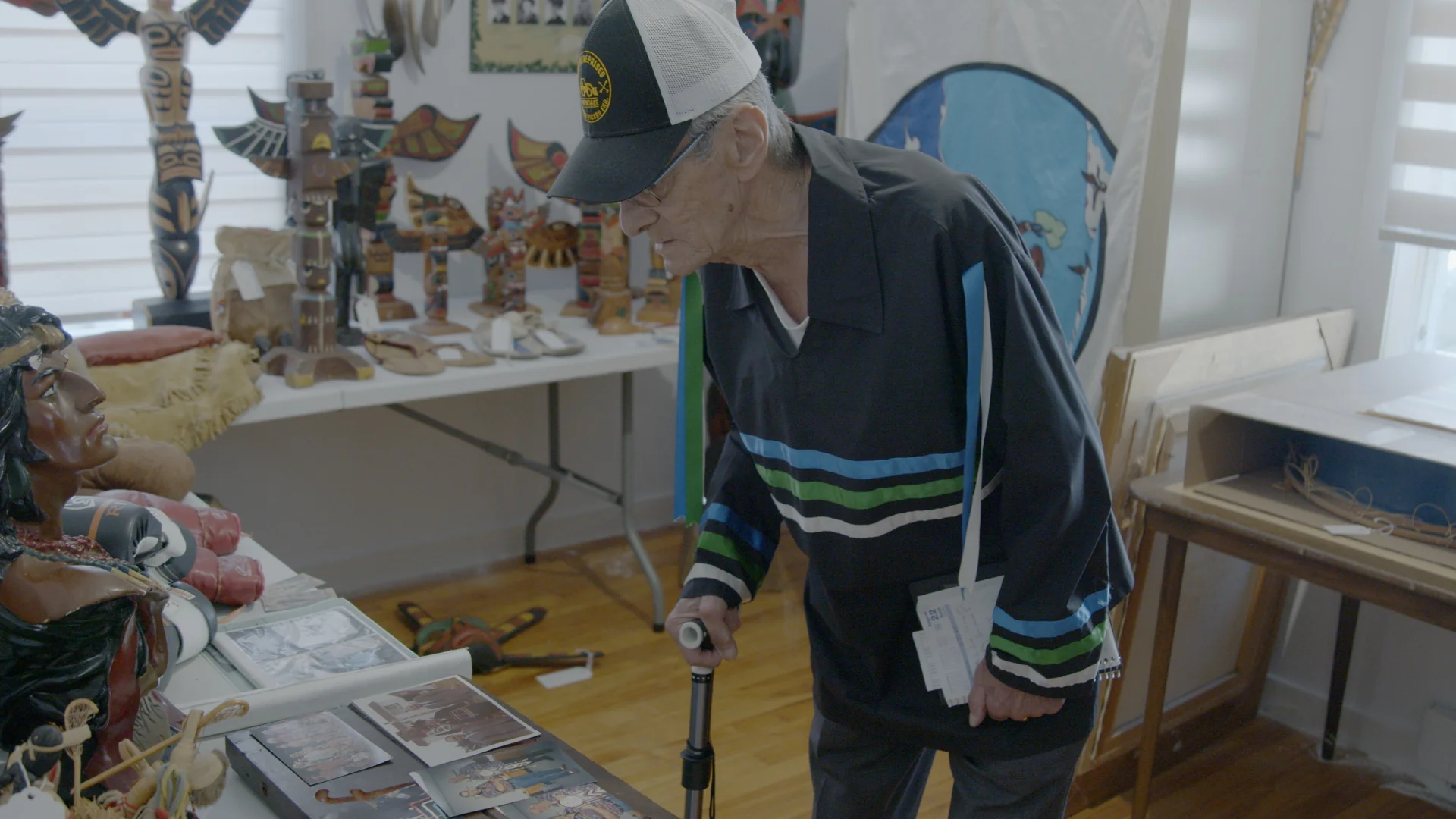 Visitor exploring carved sculptures in the gallery